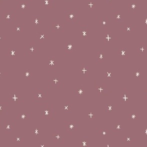 Small scale folk art style stars in the night sky in rose brown