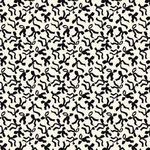 (S) Coquette black bows on a cream beige background pattern