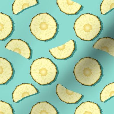 Pineapple slices on turquoise background