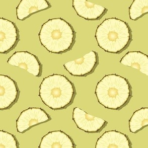 Pineapple slices on green background