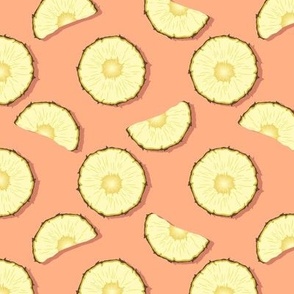 Pineapple slices on coral background