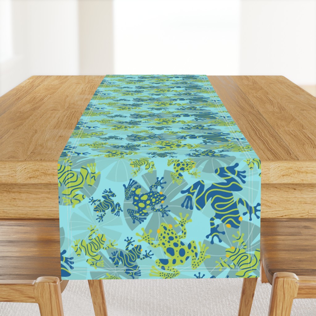 Playful Green and Blue Frogs Frolicking Across a Canvas of Overlapping Gray Lily Pads on a Light Blue Background