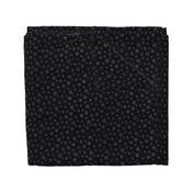 Small grey polka dots on a black background.  