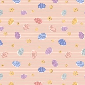 Colourful tossed easter eggs on stripe in soft pink