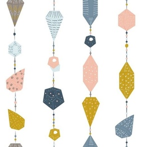 Patterned multicolor crystals in pink, blue, grey and mustard yellow on a thread, light