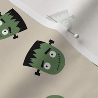 Cutesy Frankentein robot faces - halloween zombie design olive green on sand