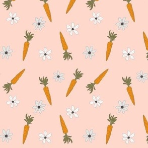Tossed carrots, flowers on pink
