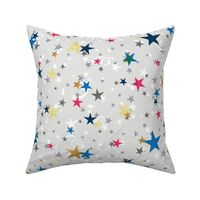 Festive pattern with stars and serpentine. Blue, white, gold, red stars on a light grey background. 