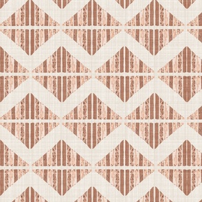 Large - A block printed design of triangles and squares and a graphic zigzag of flax coloured textured linen. Peach fuzz, rust, terracotta and orange.
