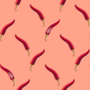 Hot peppers on a light orange background
