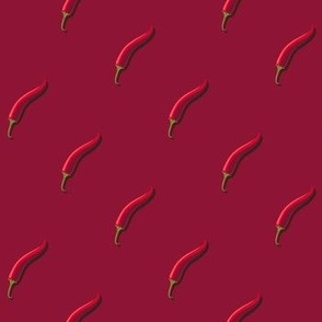 Small hot pepper on a dark red background