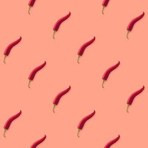 Small hot pepper on a light orange background