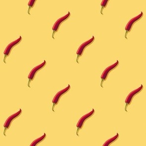 Small hot pepper on a yellow background