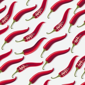 Hot peppers flying diagonally on a white background