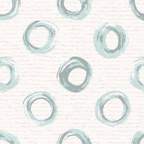 Hand drawn watercolour circles and rings – painted geometric brush strokes on a warm cream watercolour paper texture. Beige and ecru with renew blue and cyan celadon.