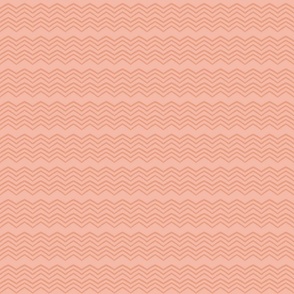 Zig zag or chevron design in a monochromatic shade of coral pink and peach, perfect quilting blender