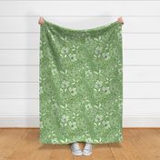 Large-scale flowers in botanical fabric design in bold green tonal hues