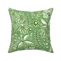 Large-scale flowers in botanical fabric design in bold green tonal hues