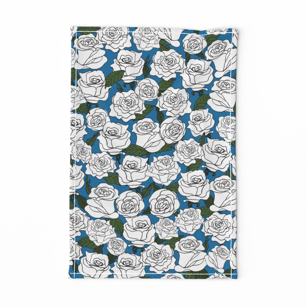 White Roses Blooming with Green Leaves and Buds on a Turquoise Blue Background