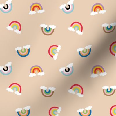 Little retro style pride rainbows with clouds on warm sand 