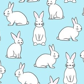 cute white bunnies on blue