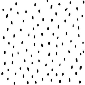 Freely placed black doodle dots on white