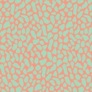 Small wild animal print, two color, blue green celadon teal on a peach pink ground.