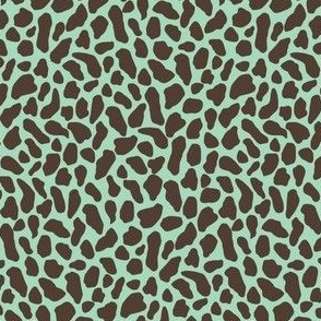 Small wild animal print, two color, dark sepia on blue green celadon teal ground.