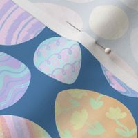 Pretty pastel Easter eggs in rainbow colours  - blue background