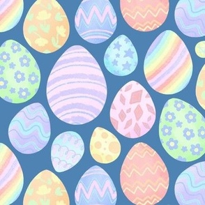 Pretty pastel Easter eggs in rainbow colours  - blue background