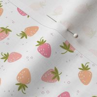 Scattered Bright pink and orange strawberries on white | small scale