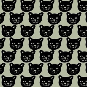 Black cat faces in rows halloween design on sage green
