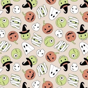Halloween cutesy monsters - zombie pumpkins ghosts and witches on sand