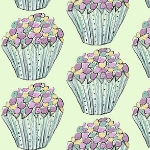 whimsical cupcake treats on mint green