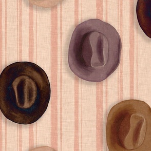 Brown leather Cowboy hats hanging on a pink striped wall