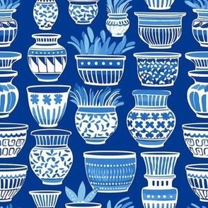 ornamented clay pots on blue