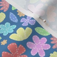 Mock Patchwork  Felt Florals in Pastel Rainbow Colours on a blue background 