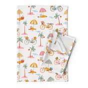 Biking the beaches – bicycles on the beach with palm trees and umbrella’s with pic nic basket and inflatabbles