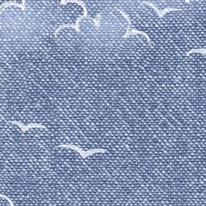 Chambray Cotton Clouds with Seagulls in Stonewash Blue (xl scale) | Summer sky, hand drawn clouds and birds on natural cotton, chambray pattern, warp and weft weave pattern, seaside sky on stonewash denim blue, ocean decor.