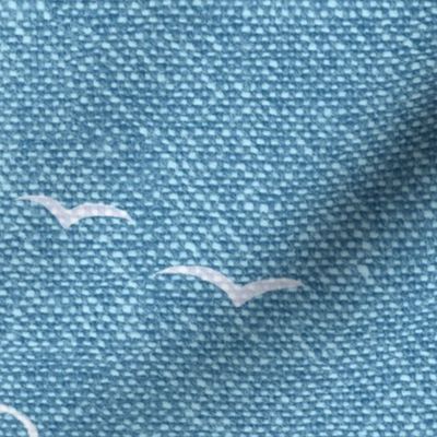 Chambray Cotton Clouds with Seagulls in Bahama Blue (xxl scale) | Summer sky, hand drawn clouds and birds on natural cotton, chambray pattern, warp and weft weave pattern, tropical sky in Caribbean blue, ocean decor.