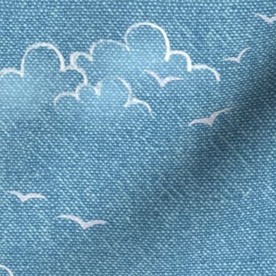 Chambray Cotton Clouds with Seagulls in Bahama Blue (large scale) | Summer sky, hand drawn clouds and birds on natural cotton, chambray pattern, warp and weft weave pattern, tropical sky in Caribbean blue, ocean decor.