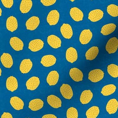 Ditsy yellow lemons on blue background