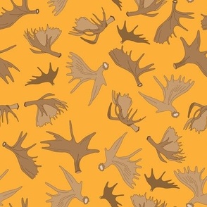 Moose Antlers Scattered on an Orange Background Creating a Seamless Surface Pattern Design