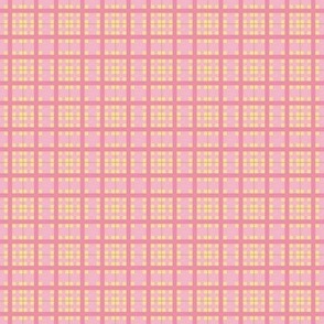 Plaid pattern in soft pink and yellow lines on a soft peach pink background