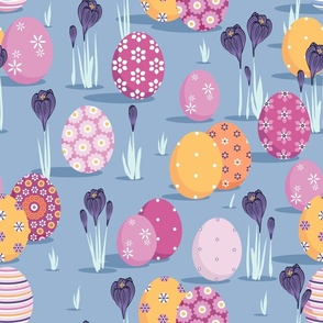 Painted eggs and crocuses on a gray-blue background