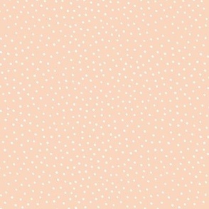 White hand drawn scattered dots on pastel peach | small