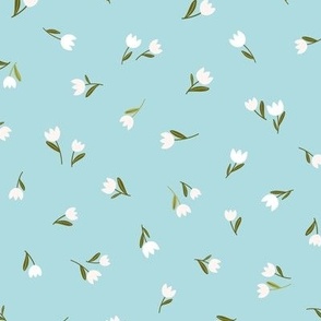 Delicate white tulips on baby blue