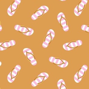 Flip-flops pink and white on ochre background
