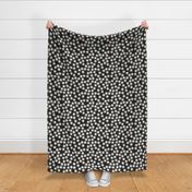 Small Block Printed Field of Polka Dots in ecru off white on soft black