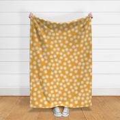 Large Block Printed Field of Polka Dots in deep cream on amber yellow